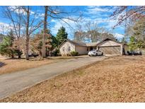 Charming single-story home featuring a long driveway and an attached two-car garage at 20 Juniper Se Ln, Cartersville, GA 30121