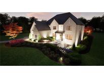 Stunning exterior view of home showing stone facade, backyard, and professionally landscaped yard at 3680 Tanglewood Se Dr, Atlanta, GA 30339