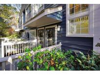 Charming townhouse exterior with blue siding, covered entry, and well-kept landscaping at 1482 N Crossing Ne Cir, Atlanta, GA 30329