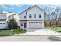 Charming two-story home with a two-car garage and well-maintained lawn at 7608 Parkland Bnd, Fairburn, GA 30213