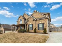 Charming two-story brick home with a well-manicured lawn and traditional architectural details under a bright blue sky at 3823 Dragon Fly Ln, Loganville, GA 30052
