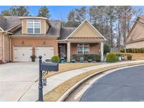 Charming brick home featuring a two-car garage and well-manicured landscaping at 498 Townsend St, Grayson, GA 30017