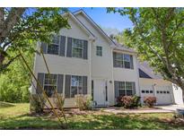Charming two-story home with vinyl siding, gray shutters, landscaped yard, and an attached two car garage at 4832 Hidden Creek Pl, Decatur, GA 30035