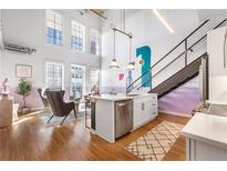 Bright living room features an open layout, modern kitchen island, high ceilings, and large windows for natural light at 260 18Th Nw St # 10202, Atlanta, GA 30363