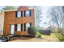 Two-story brick home with black shutters and a well-maintained lawn at 5582 Windwood Rd, Atlanta, GA 30349