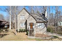 Charming home featuring a welcoming front porch and classic architectural details, nestled in a wooded setting at 108 Kelly Ct, Dallas, GA 30157