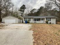Charming single story home with detached garage, large front yard, and inviting front porch at 5115 Cascade Palmetto Hwy, Fairburn, GA 30213