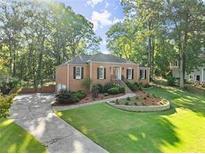 Charming single-story brick home with mature trees and a well-manicured lawn at 3494 Old Suttons Way, Marietta, GA 30062