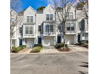 Charming townhomes featuring a modern, gray exterior, multiple windows, and well-manicured landscaping at 1126 Village Se Ct, Atlanta, GA 30316