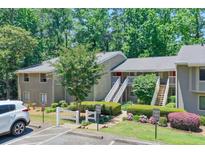 Inviting condo exterior with well-manicured landscaping and ample parking space at 2937 Torreya Way, Marietta, GA 30067