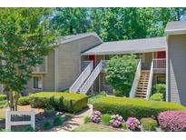 Two-story condo building featuring well-maintained landscaping and inviting red doors at 2937 Torreya Way, Marietta, GA 30067