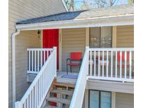 Charming front porch with red door, white railing, and chairs creating an inviting entryway at 2937 Torreya Way, Marietta, GA 30067