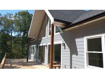 Charming exterior of home with a wooden deck and large windows providing beautiful natural light at 8155 Stone Hill Rd, Cumming, GA 30028