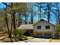 Charming home featuring a two-car garage, stone accents, and a well-maintained yard at 326 Rockland Way, Lawrenceville, GA 30046