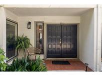 Inviting front entryway with double doors, a decorative lantern, and well-maintained landscaping at 3772 Paces Ferry West Se, Atlanta, GA 30339