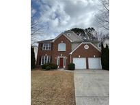Charming two-story brick home with a well-maintained lawn and a two-car garage in a suburban setting at 3734 Christine Nw St, Kennesaw, GA 30144