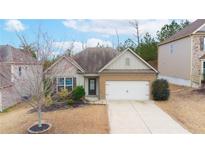 Charming single-story home featuring a two-car garage and well-maintained landscaping at 4830 Roseman Trl, Cumming, GA 30040