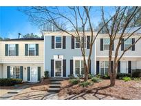Charming townhome with a well-manicured front yard and a welcoming entrance at 2003 Queen Anne Ct, Sandy Springs, GA 30350