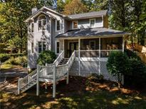 Charming two-story home with a welcoming front porch and well-maintained landscaping at 725 Dena Dr, Canton, GA 30114