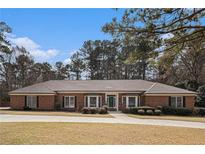 Charming brick home with a well-manicured lawn and mature trees in a desirable neighborhood at 3003 Hanover Se Ln, Conyers, GA 30094