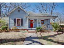 Charming single-Gathering home with a welcoming front porch and colorful red door at 3065 Park St, East Point, GA 30344
