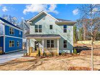 Charming two-story home with a welcoming front porch and newly landscaped yard at 1098 Wedgewood Nw Dr, Atlanta, GA 30318