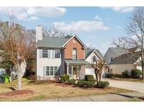 Charming two-story home featuring a mix of brick and siding, complemented by shutters and a landscaped front yard at 1902 Elm Park Dr, Hampton, GA 30228