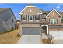 Charming brick two-story home featuring a two-car garage and well-maintained landscaping at 962 Edwin Ln, Sugar Hill, GA 30518