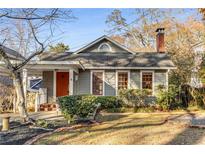 Charming home featuring a brick chimney, orange front door, and well-maintained landscaping at 315 W Benson St, Decatur, GA 30030