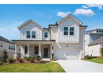 Charming two-story home with a landscaped front yard, brick facade and a two-car garage at 1466 Auburn Glen Rd, Dacula, GA 30019