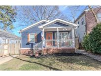 Charming blue home with a cozy front porch and landscaped front yard, perfect for relaxing at 988 Farrington Se Pl, Atlanta, GA 30315