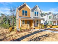 Charming two-story home featuring a welcoming front porch and a well-maintained lawn in a vibrant neighborhood at 1106A Wedgewood Nw Dr, Atlanta, GA 30318