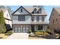 Charming two-story home with a two-car garage, covered porch, brick accents, and landscaped front yard at 4916 Kentwood Dr, Marietta, GA 30068