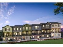 Charming townhomes with varied colors, brick accents, and inviting front entrances, landscaped for curb appeal at 525 Burlrush Ln # 16, Alpharetta, GA 30009