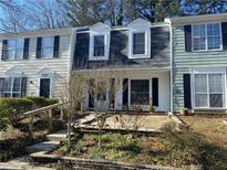 Inviting townhomes featuring dormer windows, dark shutters, and stone paver front patios at 3228 Shadow Walk Ln, Tucker, GA 30084