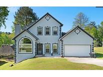 Charming home with gray stucco, neat trim, and a well-manicured green lawn at 6797 Yorkdale Ct, Lithonia, GA 30058