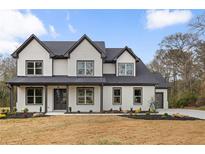 Stunning two-story home featuring white painted brick, a dark roof, and covered front porch at 1629 Phillips Rd, Lithonia, GA 30058