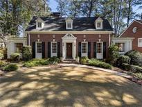 Charming brick home with dormer windows, black shutters, and a well-manicured lawn in a desirable neighborhood at 1605 E Sussex Ne Rd, Atlanta, GA 30306