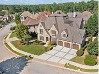 Stunning brick home featuring a three-car garage and professionally landscaped front yard at 1965 Carlotta Ct, Atlanta, GA 30345