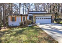 Charming single-story home featuring a stone facade, attached garage, and well-maintained front lawn at 3085 Nappa Trl, Stone Mountain, GA 30087