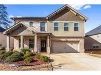 Charming two-story home with a well-manicured lawn and an attached two-car garage at 3596 Maple Hill Rd, Lithonia, GA 30038