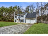 Charming two-story home with a spacious front yard and a two car garage at 4975 Rockstone Way, Acworth, GA 30101