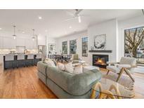 Bright, open living room with hardwood floors, fireplace, and seamless flow to the modern kitchen and dining areas at 1099 Hawthorne Ne St, Atlanta, GA 30307
