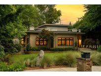 Charming brick home featuring a flat roof, meticulously landscaped front yard, and an inviting stone pathway, creating curb appeal at 1181 Fairview Ne Rd, Atlanta, GA 30306