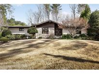 Attractive home with a well-maintained lawn and beautiful landscaping at 437 Hollydale Nw Ct, Atlanta, GA 30342