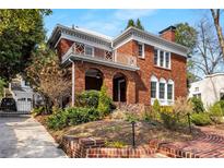 Charming two-story brick home with a beautifully landscaped front yard and inviting arched entryway at 1272 Oakdale Ne Rd, Atlanta, GA 30307