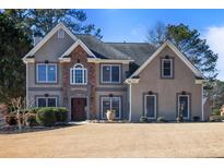 Charming two-story home showcasing a well-manicured lawn and welcoming front entrance at 1278 Crown Ter, Marietta, GA 30062