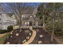 Charming brick home featuring a stone pathway, manicured landscaping, and beautiful architectural details at 239 E Wesley Ne Rd, Atlanta, GA 30305