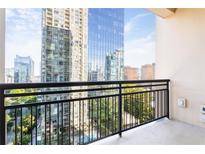 Enjoy skyline views from the private balcony with black metal railing, offering an outdoor living space at 3445 Stratford Ne Rd # 1605, Atlanta, GA 30326