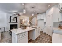 Bright kitchen featuring a center island, white cabinets, and modern pendant lighting at 2702 Ne Almand Lane, Conyers, GA 30013
